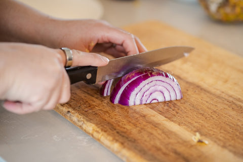 chopping a red onion into small squares