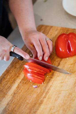 chopping up red bell pepper into small pieces