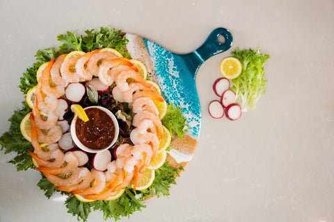 shrimp cocktail served on an ocean vibes resin cheese board