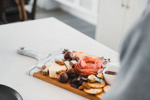 Valentines day themed cheese board served on a resin accented acacia board