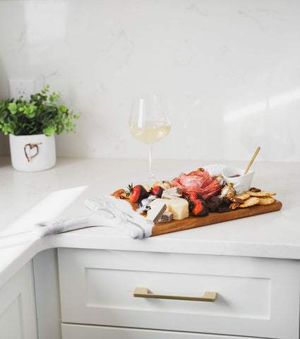 Valentines themed cheese board served in white kitchen with wine