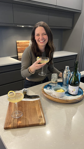 woman holding her glass of french 75 cocktail