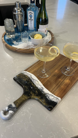 french 75 cocktail served on large resin cheese board