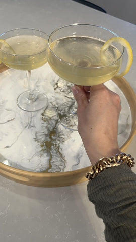 french 75 cocktail served on a gold quartz resin bamboo tray