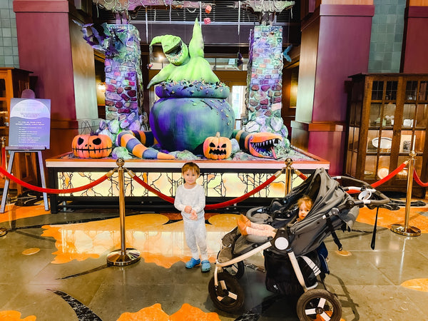 The Bumbleride Indie Twin Stroller in front of Nightmare Before Christmas Disney display.