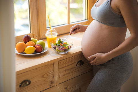 Pregnant woman eating healthy meal after a workout