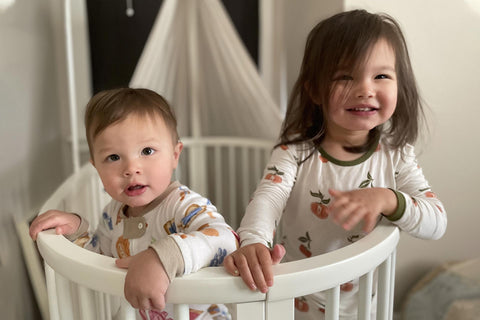 Willa and Linc in a crib