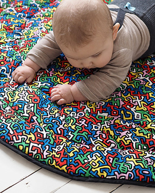 Baby on Monty Brazil play mat from Etta Loves' Keith Haring collection.