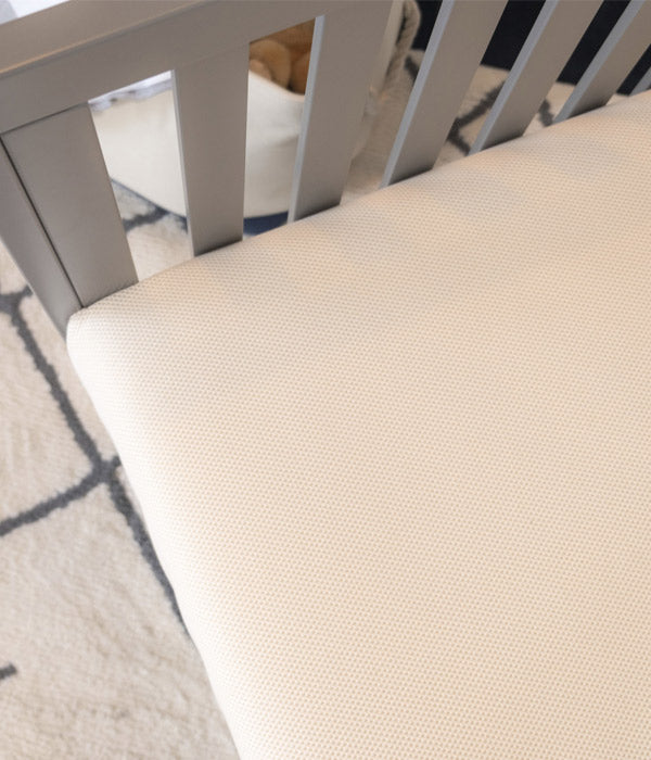 Close up photo of Naturepedic breathable crib mattress.