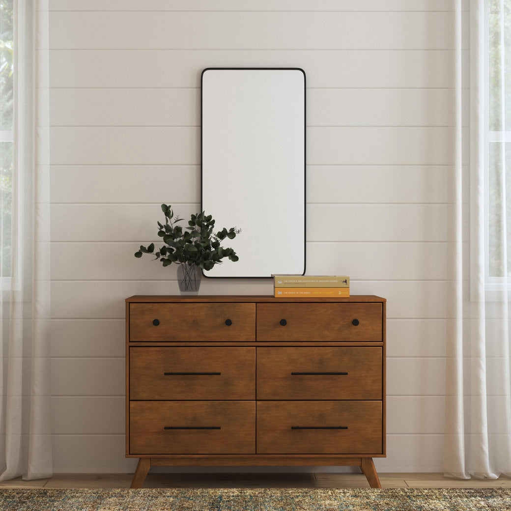 Front view of DaVinci Otto 6-Drawer Dresser with some books and a plant on top  in -- Color_Walnut