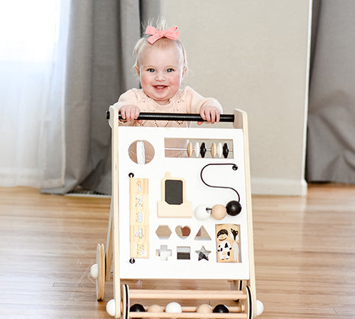 cute baby playing with the activity walker