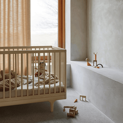oiled ash caravan crib in the bedroom with mattress and toys on the crib and floor -- Lifestyle