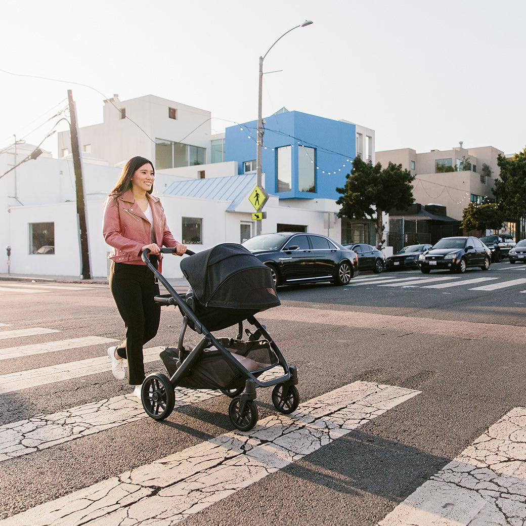 women pushing the vista v2 stroller while crossing the street -- Color_Jake