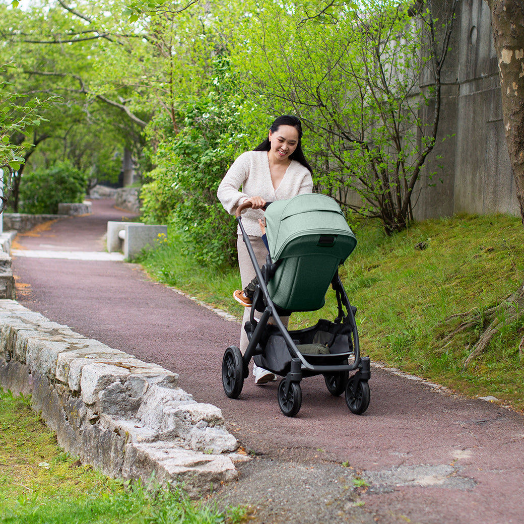 Woman pushing the vista stroller while walking on the street -- Color_Gwen