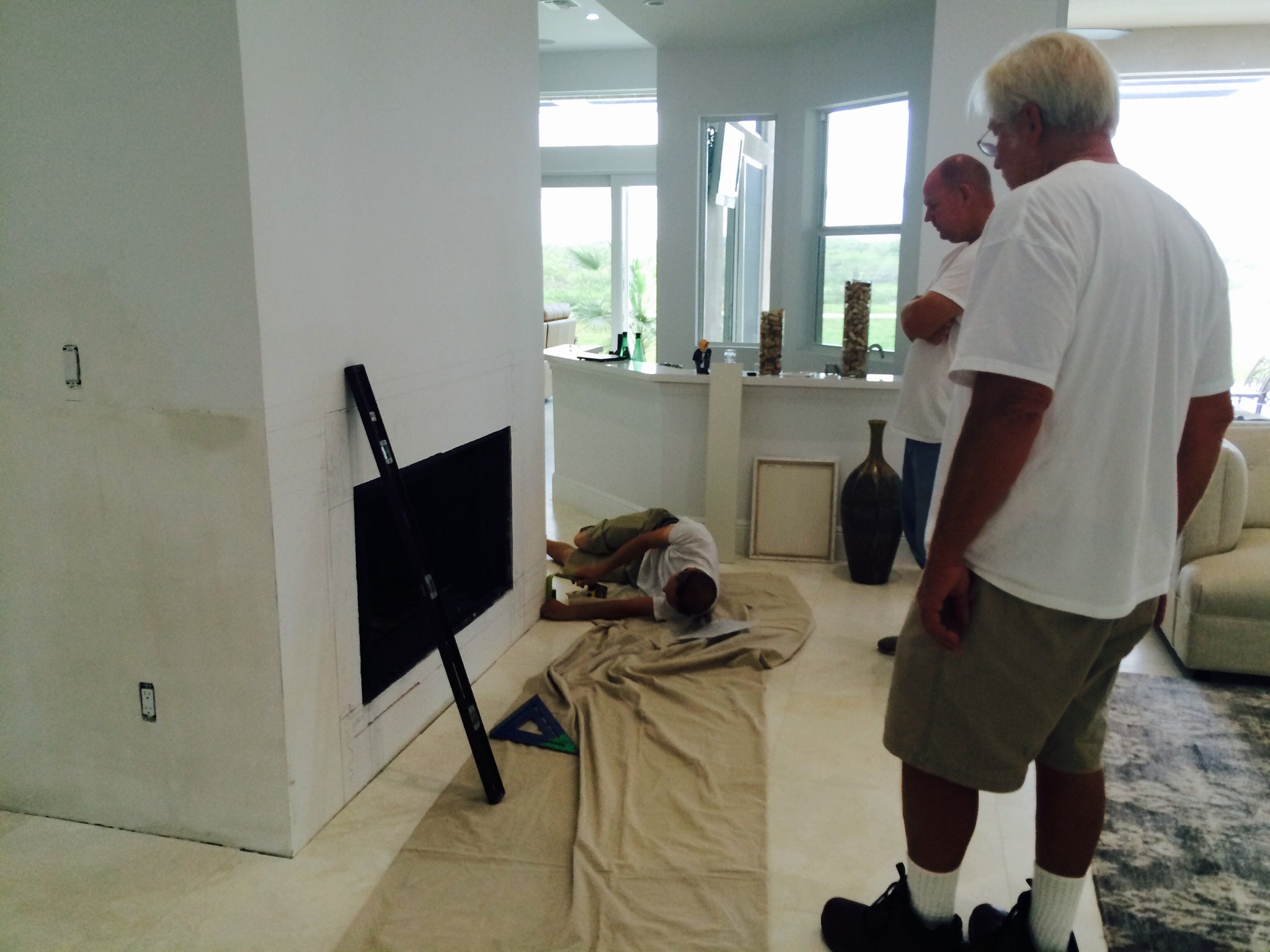 Laying out the stone on the fireplace.