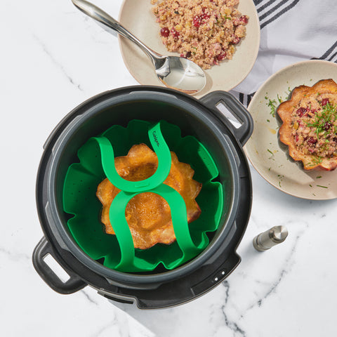 Acorn squash in a vegetable steam cooking in an Instant Pot