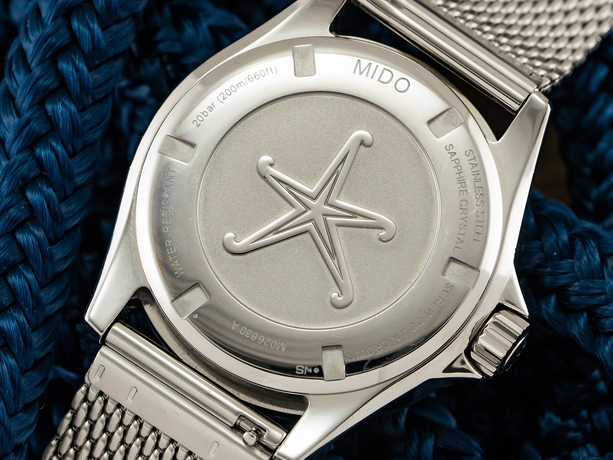 Mido Ocean Star caseback - starfish emblem