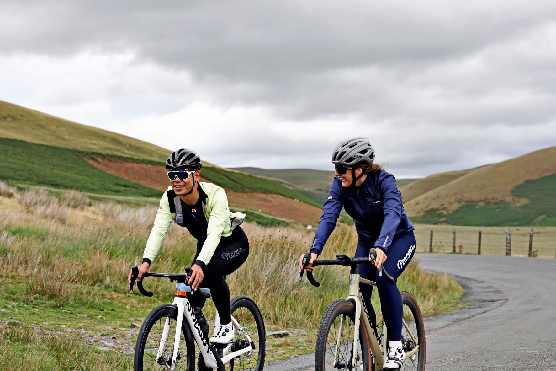 man and woman cycling in wales