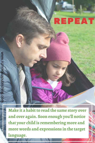 A Father is reading a story book for his daughter outside the tent 