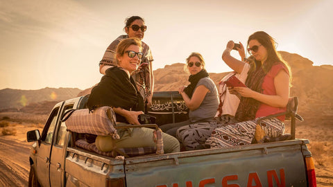 Group of travelers in the back of a pickup truck