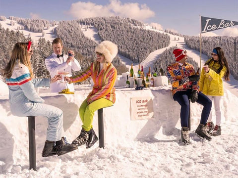 A group of five enjoying apres ski on top of a mountain