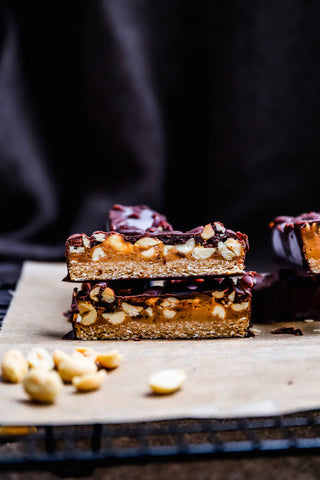 Cross-section of vegan chocolate homemade peanut butter snickers bars