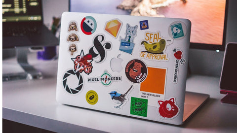 macbook covered in custom stickers