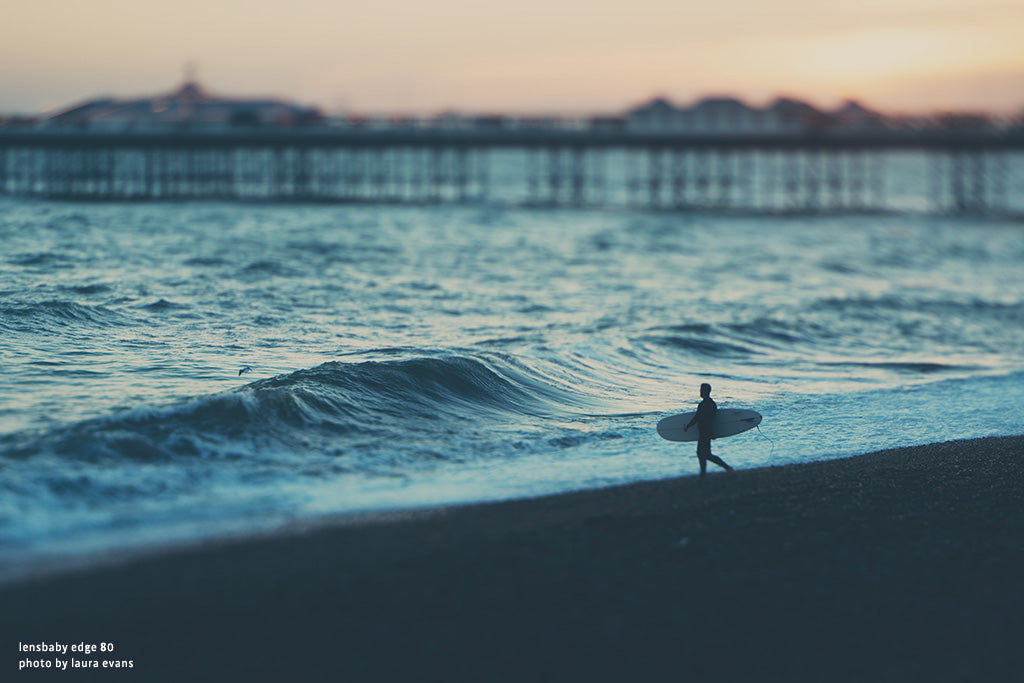 surfer at dusk in front of pier beach wave edge 80  lensbaby manifesto discovery is our joy