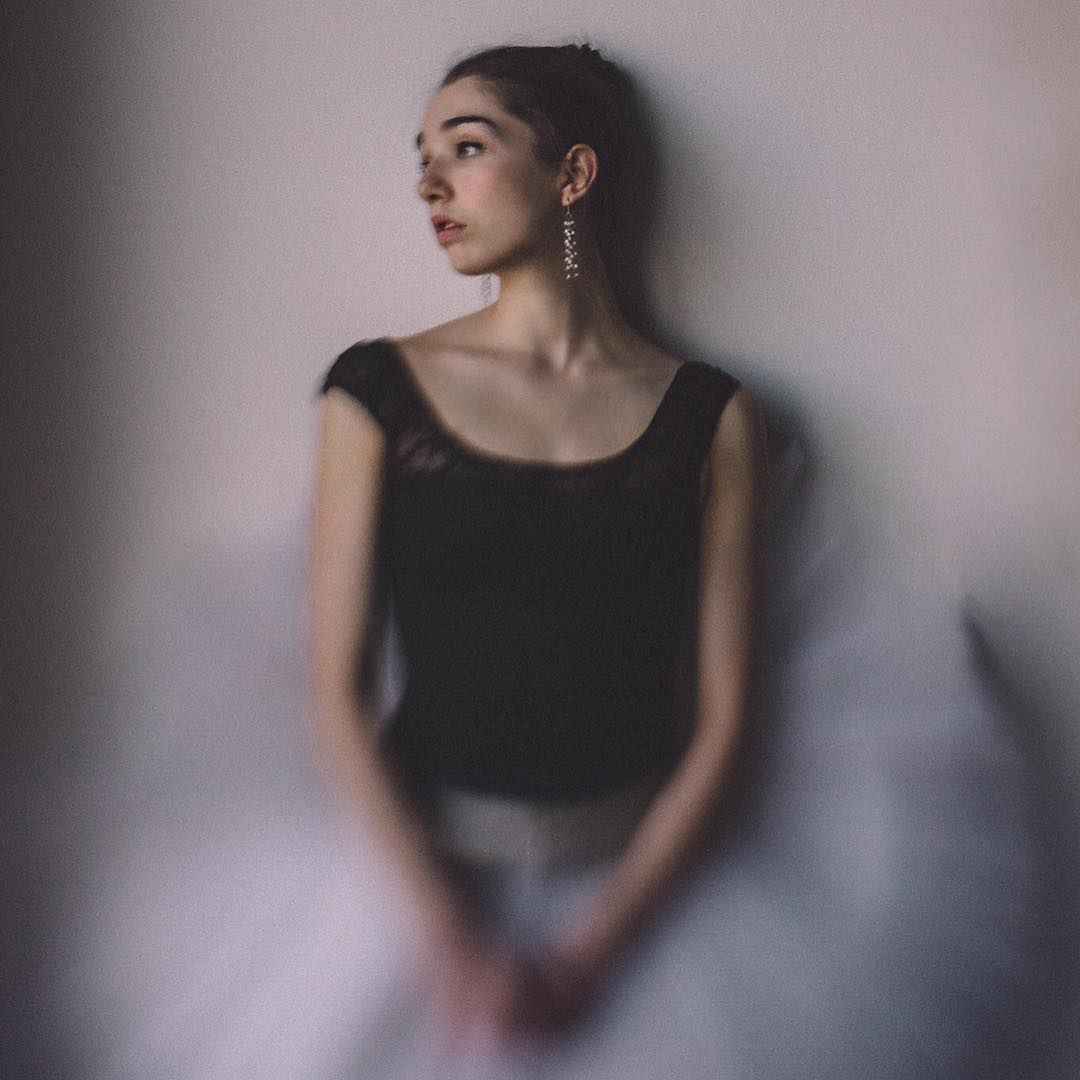 ballet dancer in black leotard pink tutu looks over shoulder selective focus Lensbaby featured photos Velvet 56