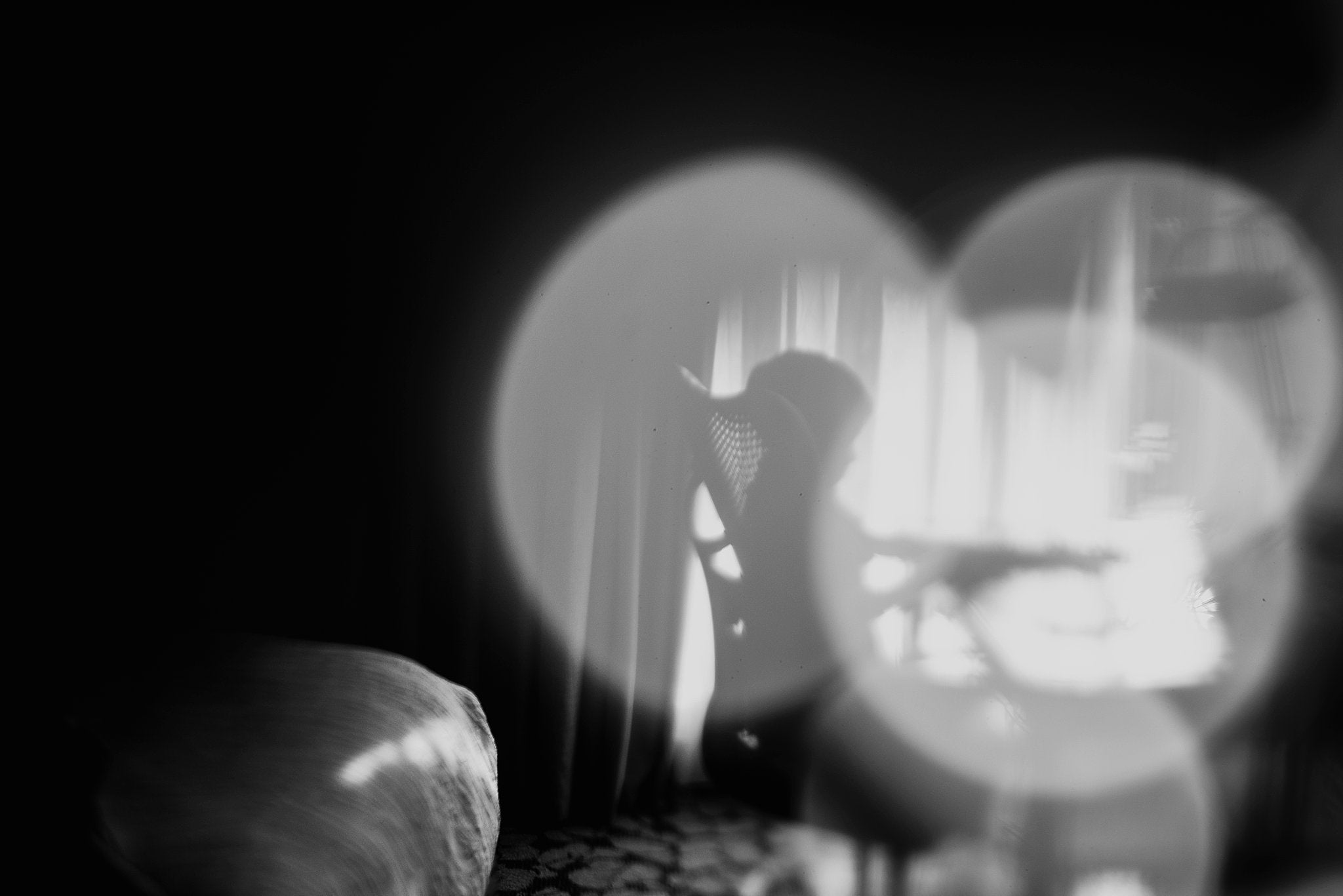 silhouette of boy in chair bokeh light black and white Chelsea Lyn Lensbaby Challenge