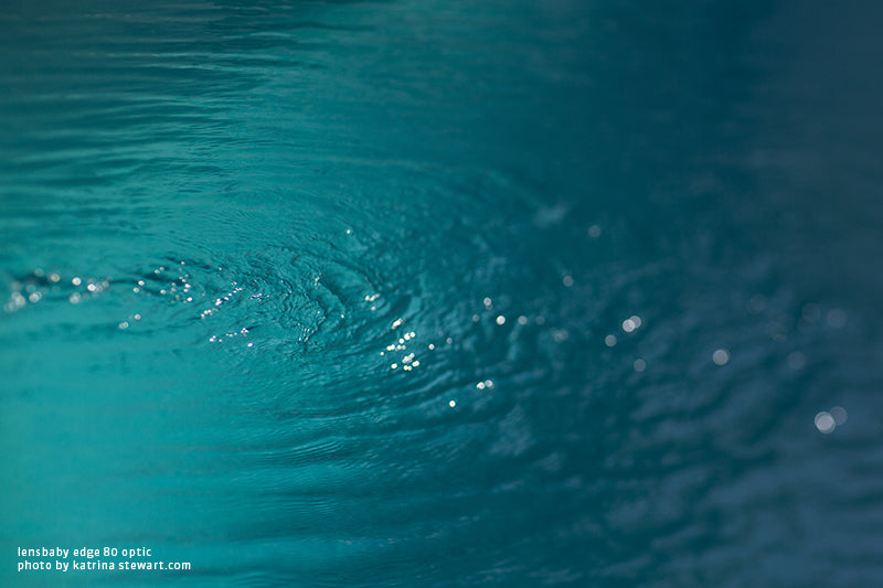 Water ripples in a clear blue-green pool using tilt shift effects by Katrina Stewart and the Lensbaby Edge 80 Optic.
