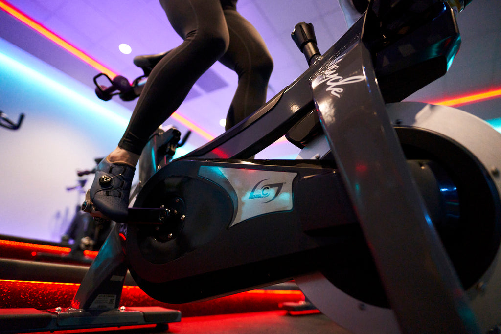Clipping in while indoor cycling at a spin studio