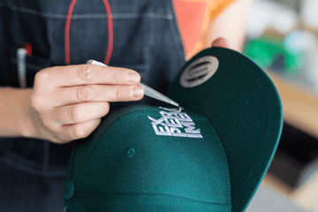 boy embroidering cap