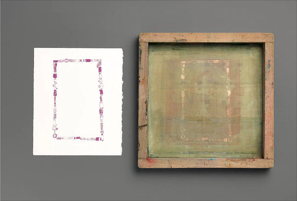 A finished screen printed design on paper placed beside the used screen printing frame that created it.