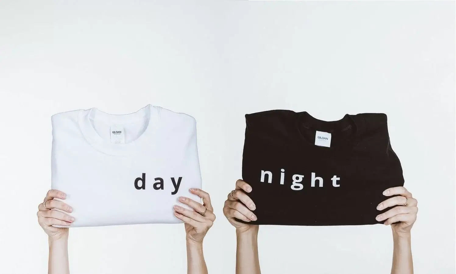 two boys holding DTG-printing shirts