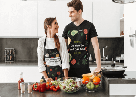 Couples with personalized aprons cooking in the kitchen