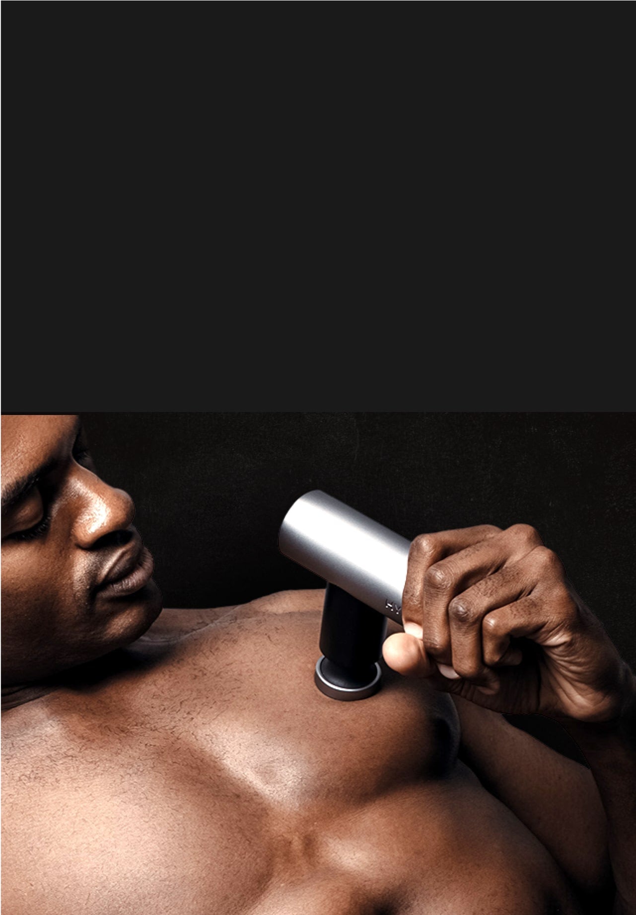 Man using Hydragun Atom Mini Massage Gun