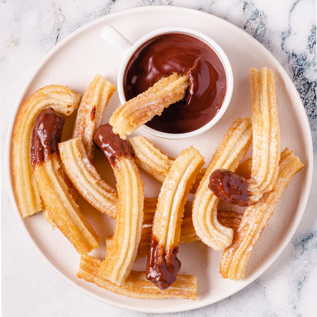 churros with mexican chocolate sauce on a plate