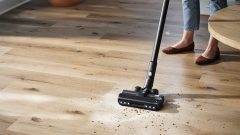 Model vacuuming the floor with Levoit VortexIQ™ 40 Cordless Stick Vacuum