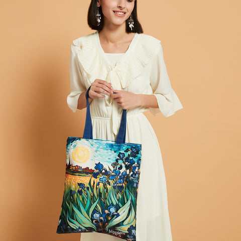 Introducing the Blossom Logo Irises Garden Bag, a stunning homage to the everlasting allure of Vincent van Gogh's masterpieces, "Irises Garden" and "Starry Night." Meticulously crafted to embody the essence of Van Gogh's artistic brilliance, this bag intricately captures the vivid hues and delicate brushstrokes, reflecting the mesmerizing interplay of colors and forms seen in the originals. Its durable yet chic 100% cotton sheeting construction makes it an ideal companion for everyday use, while the ample 40 cm x 35 cm/17.7 inches x 13.77 inches dimensions and internal pocket add practicality.