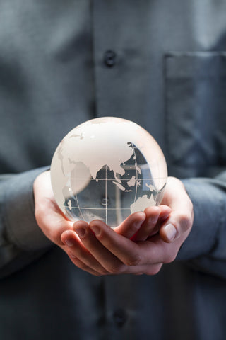 Man holding glass globe in his hands