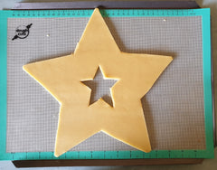 Star cutout cookie on doughcuts silicone baking mat