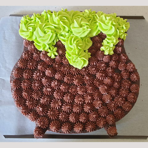 Image of cauldron cake with buttercream bubbles coming out of the top.