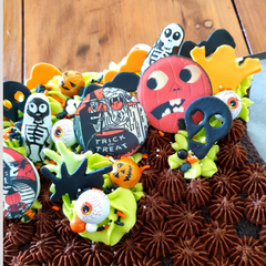 Close up of cauldron shaped cake toppers