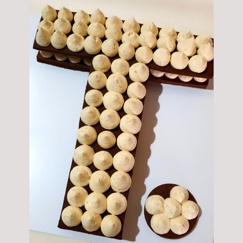 Image of letter T cookie with caramel fudge buttercream piped on top