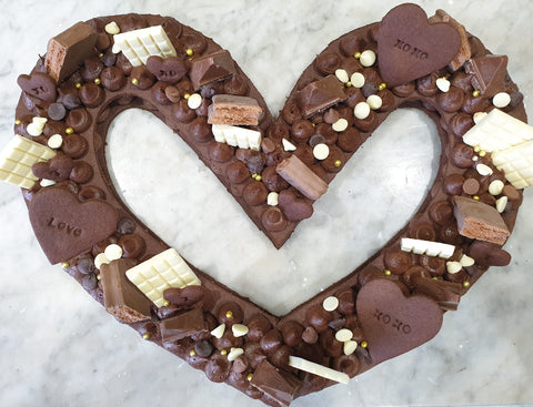 Chocolate cookie heart shaped cookie cake with chocolate buttercream