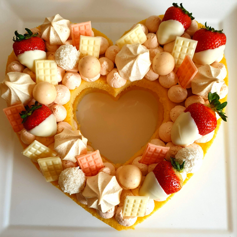 Completed vanilla buttercake heart shape with strawberry buttercream