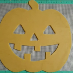 jack o lantern cookie with cutouts for eyes, nose and mouth