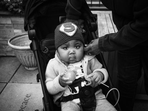 Francis Strain with a skull cap on in a stroller at Ronald McDonald House New York