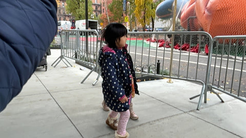 A little girl from RMH-ny watches the balloons